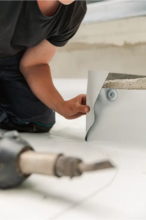 Image of a roofer completing a repair on a commercial building