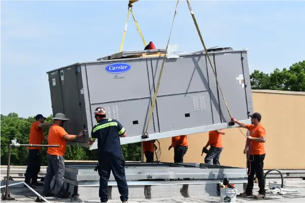 Image of workers install an hvac unit on a commercial roof