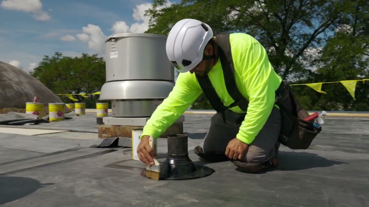 Image of a roofer completeing a repair on a commercial building