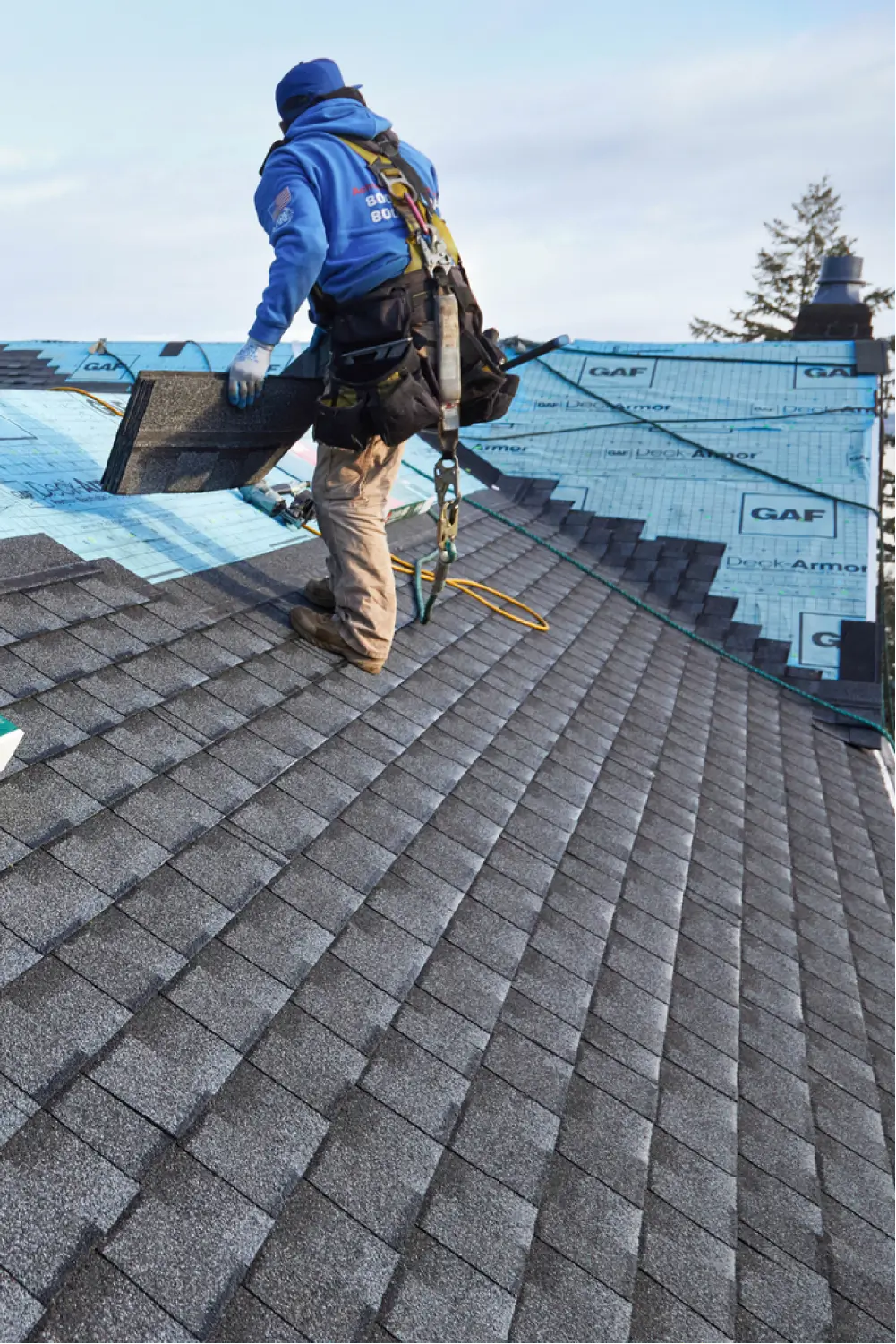Image of roofing technician installing a new shingle roof