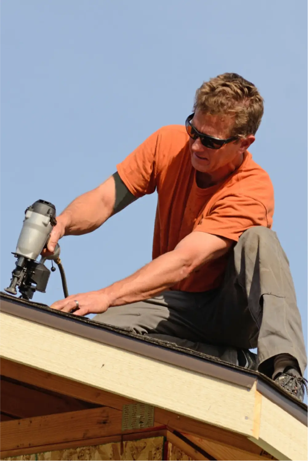 Image of roofing technician installing a new shingle roof