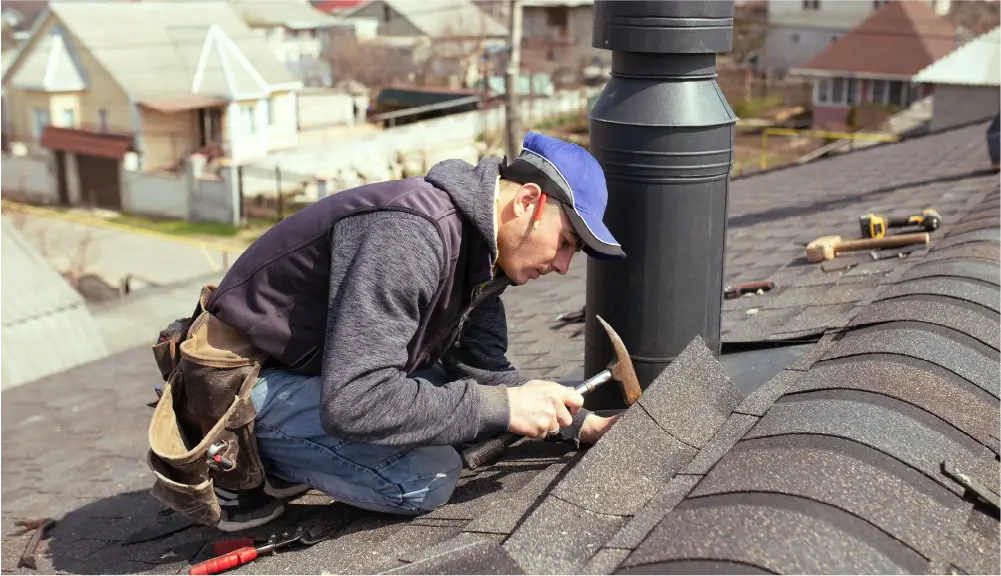 Image of roofing technician repairing a shingle roof