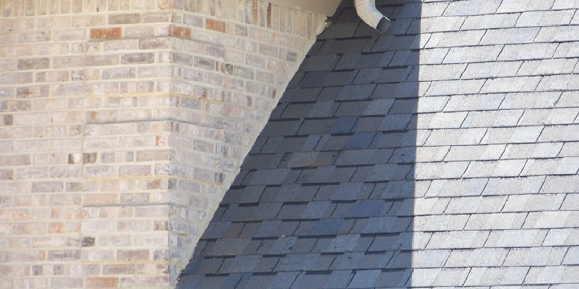 Image of roof meeting with a brick wall without the proper roof flashing