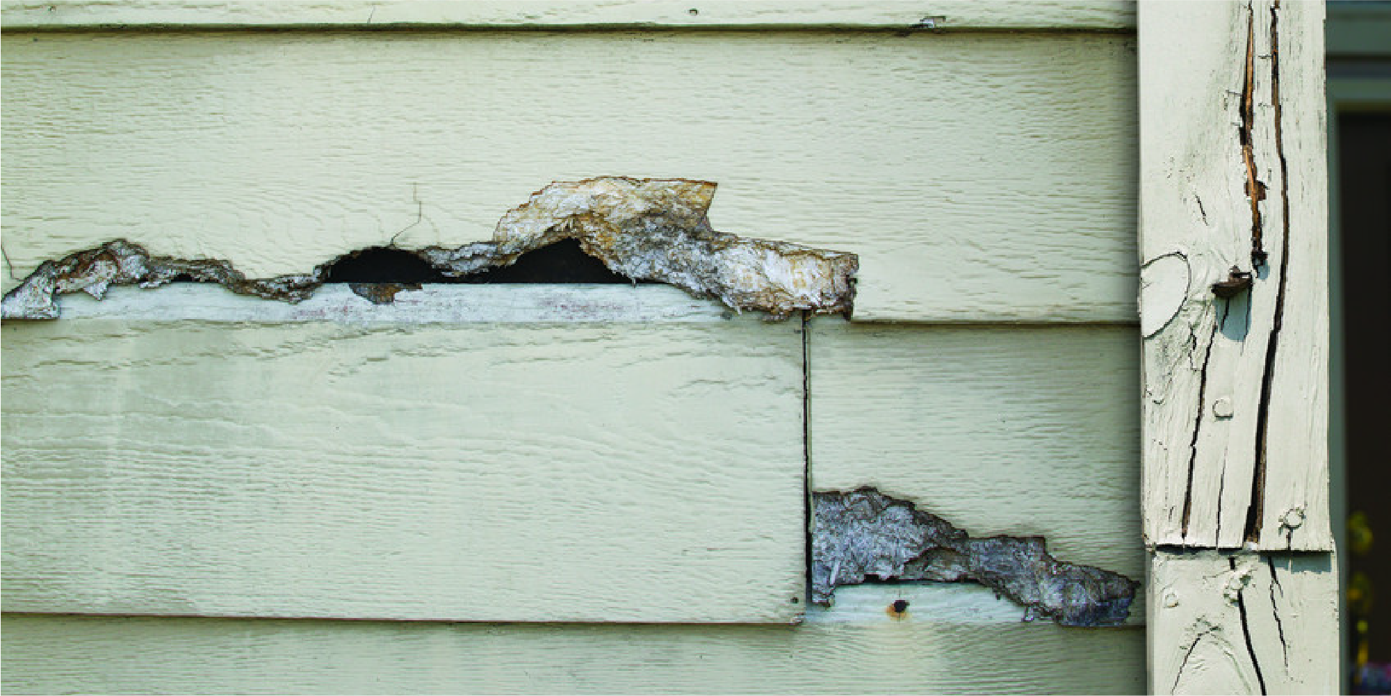 Image of rotted siding causing a roof leak around a chimney